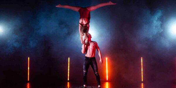 Female-Acrobat-Balancing-On-The-Hand-Of-Male-Acrobat