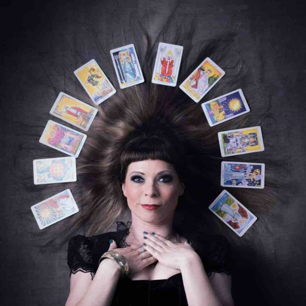 Female fortune teller surrounded by tarot cards