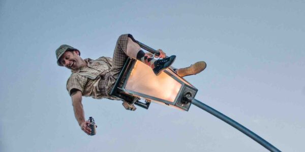 Man-Sitting-On-Swinging-Lantern