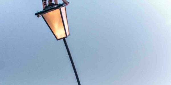 Sway-Pole-Acrobat-Attempts-To-Stand-On-Lantern
