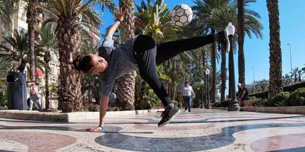 Female-Football-Trickster-Performs-Stunts-One-Handed
