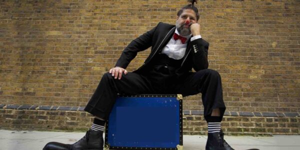 Circus-Clown-Sitting-On-Suit-Case