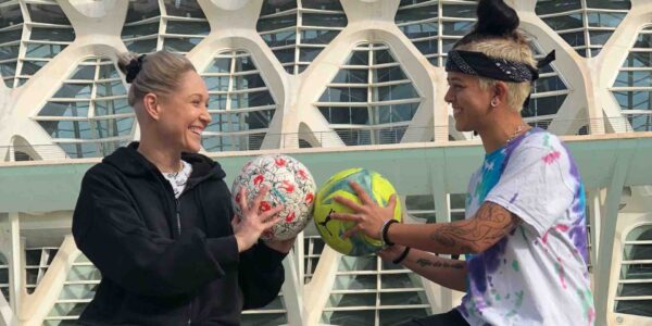 Two-Female-Football-Freestylers-Holding-Footballs