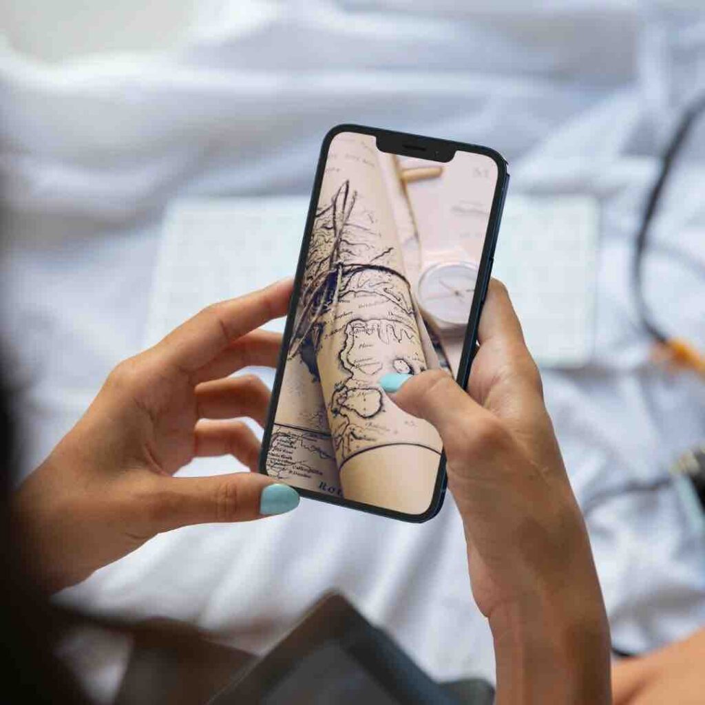 Person on phone looks for clues in online treasure hunt escape room