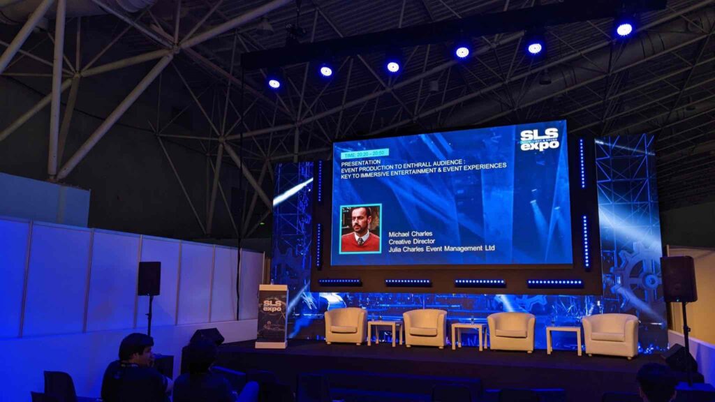 Stage with LED screen showing start slide for Michael Charles' presentation at the Saudi Light and Sound Expo in Riyadh 2022.