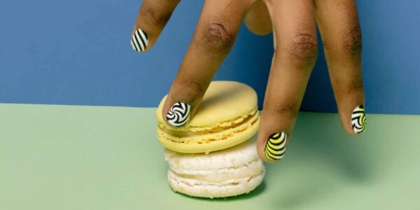 Person-Selecting-Macaron-Dessert