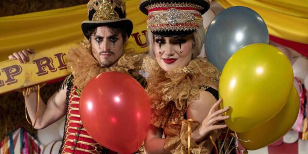 Circus-Stilt-Performers-Holding-Balloons