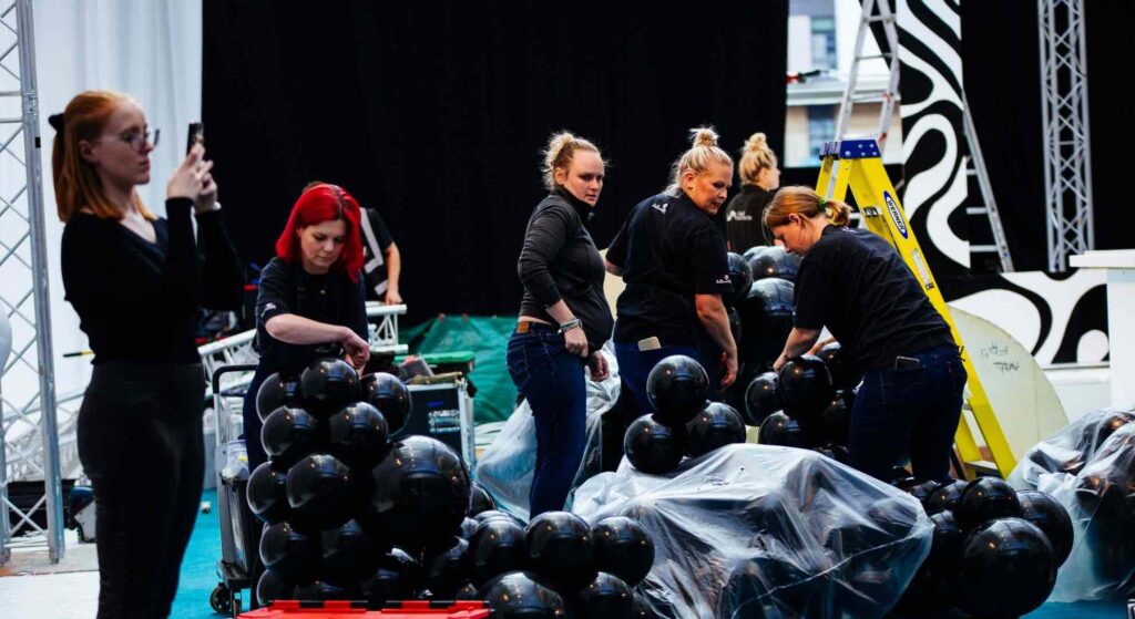 The event production team of Julia Charles Event Management on set at the Sidemen After Party assembling the set design.