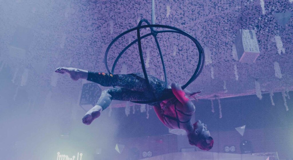 Hula hoop artist creating a buzz at an event as part of event marketing strategy.