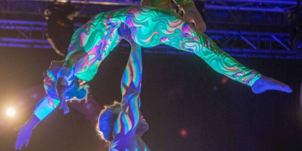 Acrobatic-Dancers-In-UV-Outfits