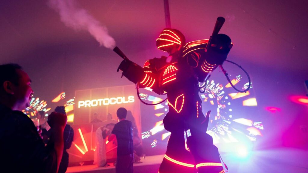 Conference robot entertainment with smoke machine entertainment guests in glowing suits.