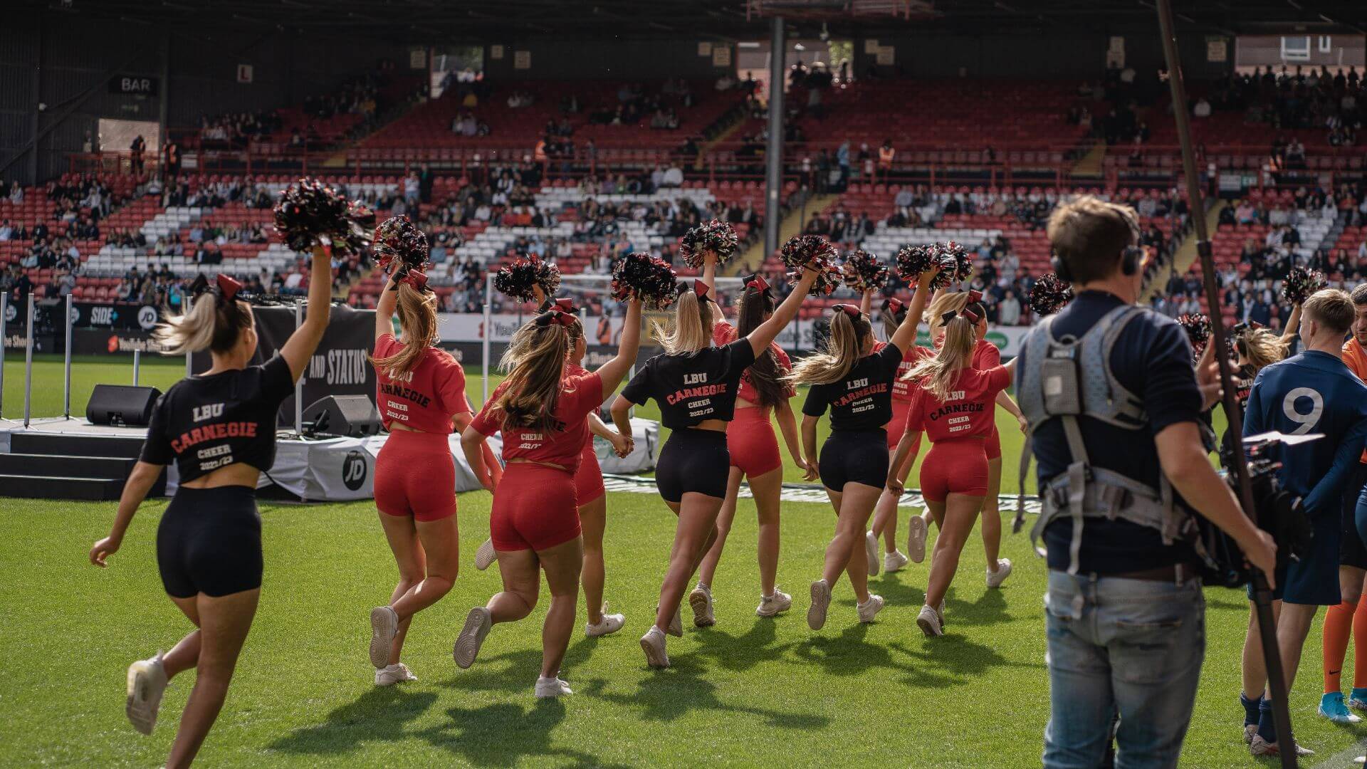 Cheerleaders running on pitch for the pre match entertainment.
