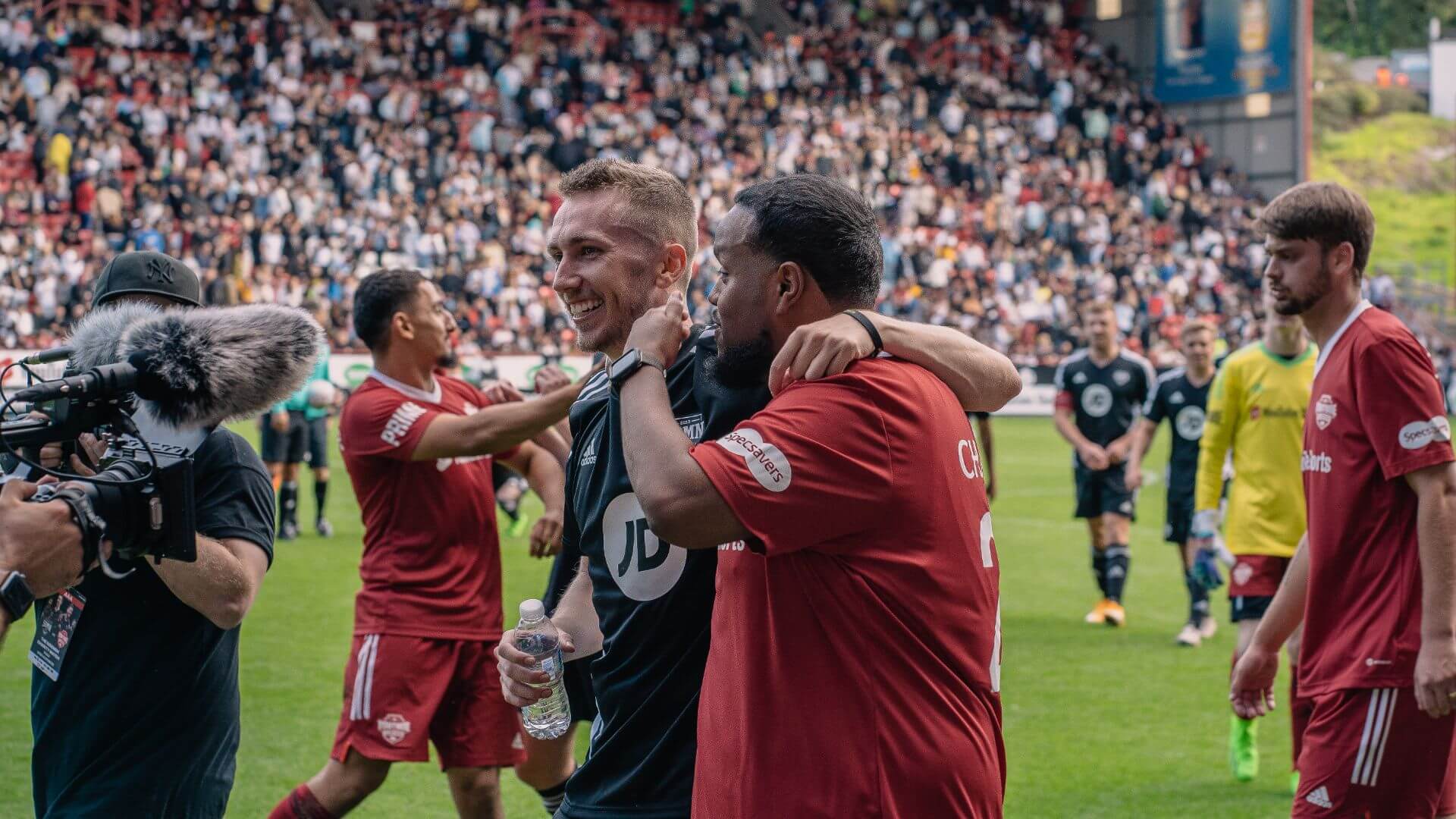 Chunkz and Miniminter walking off the pitch at the end of the match.