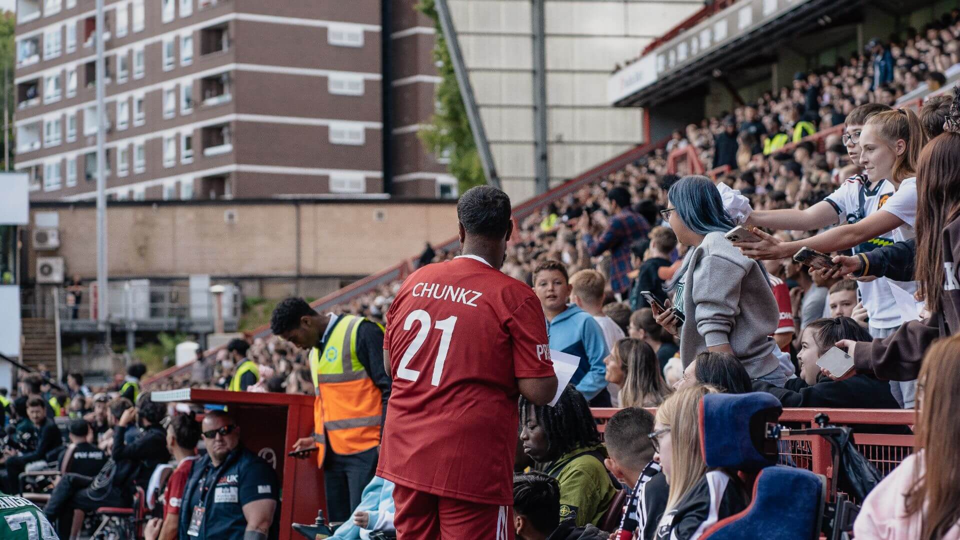 Chunkz engaging with fans at the 2022 Sidemen Charity Football match.