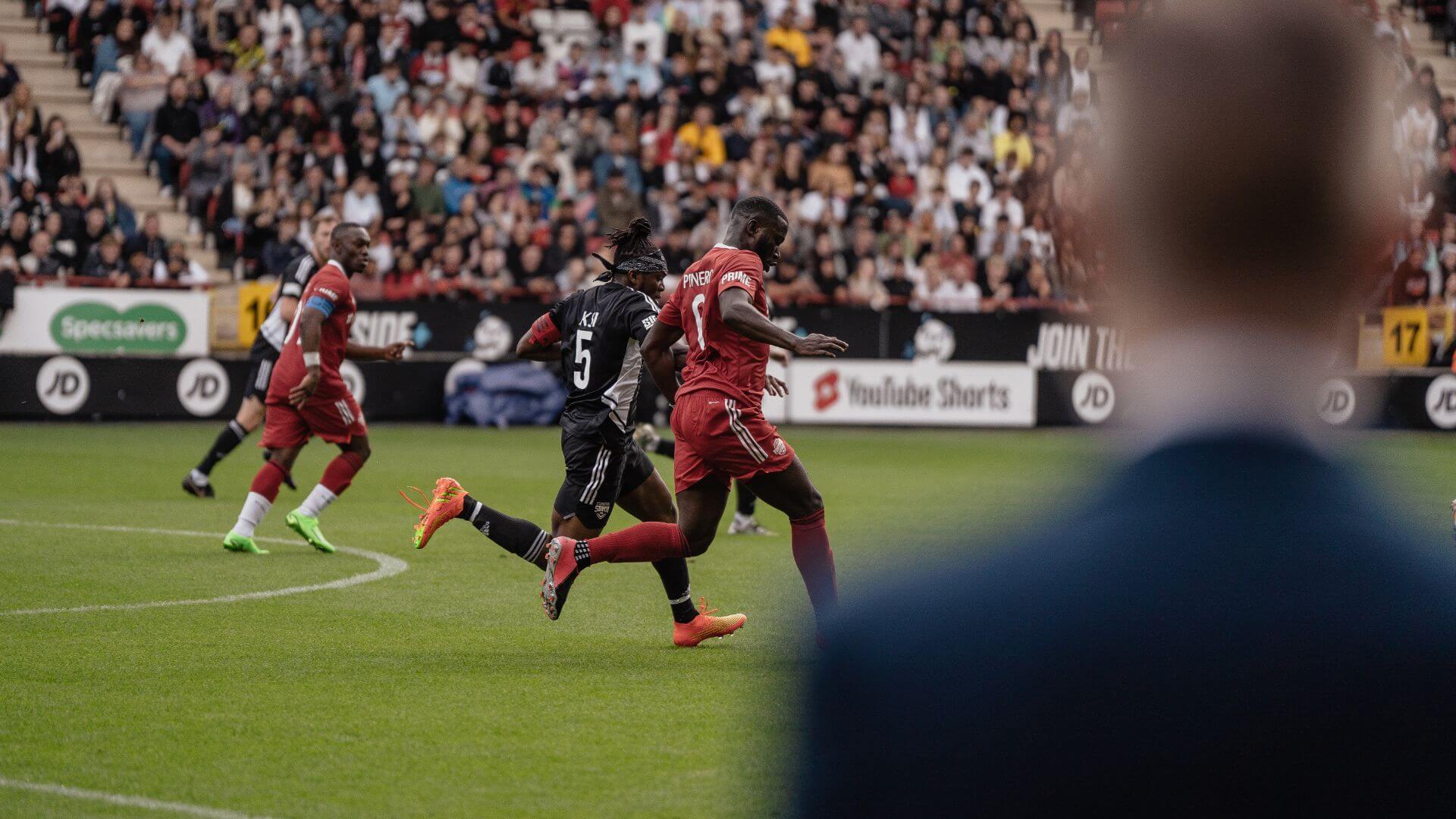 KSI chasing Harry Pinero on pitch at the 2022 Sidemen Charity Football Match.