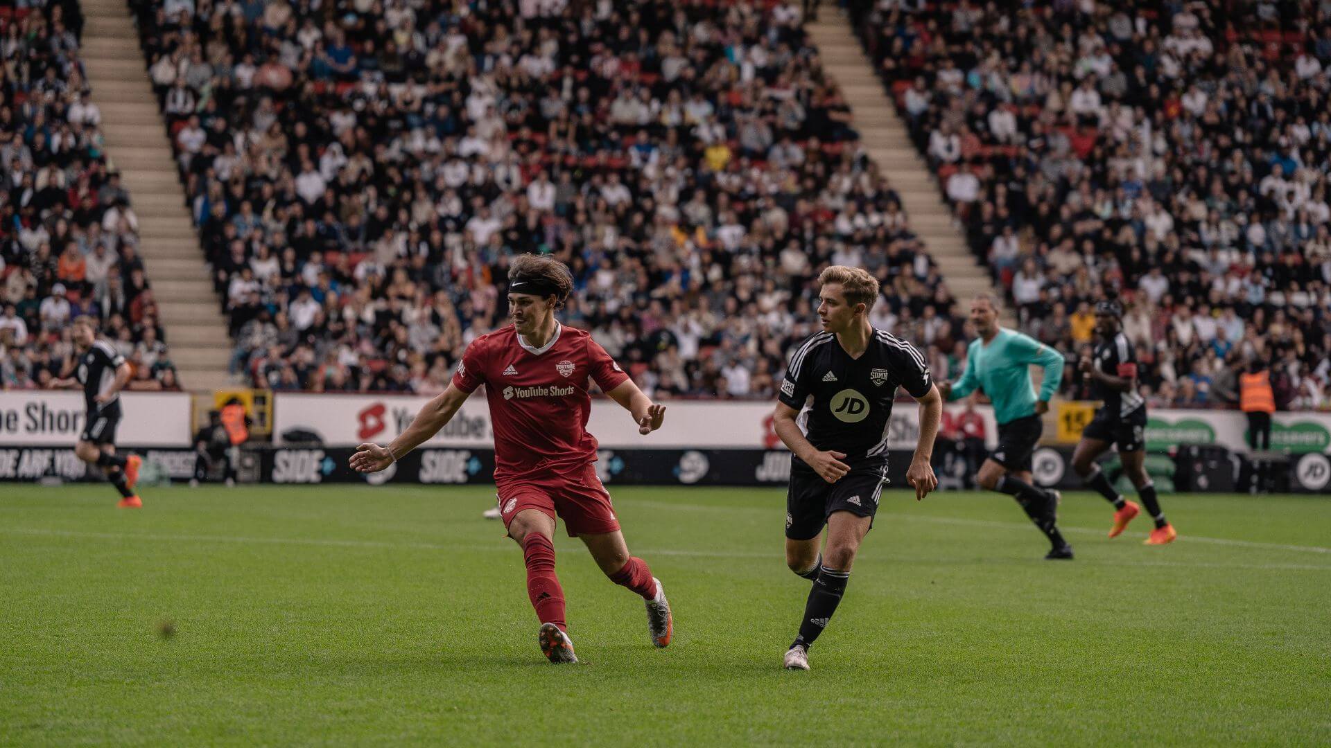 Noah Beck and ChrisMD competing for the ball.