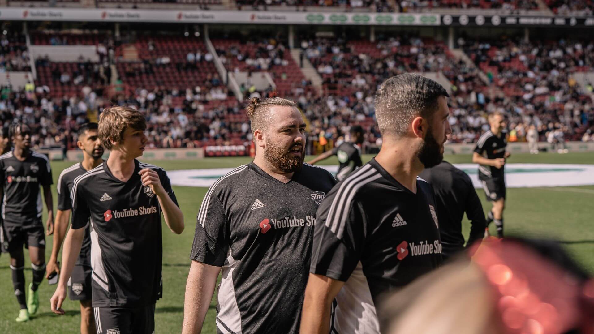 Zerkaa and Randolph walking on the pitch.