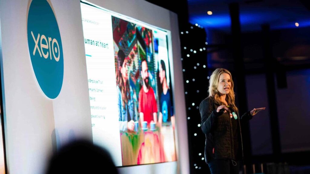 Speaker talking on stage at Xero Accounting conference.
