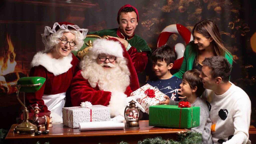 Santa Entertainer with Mrs Claus gifting children presents