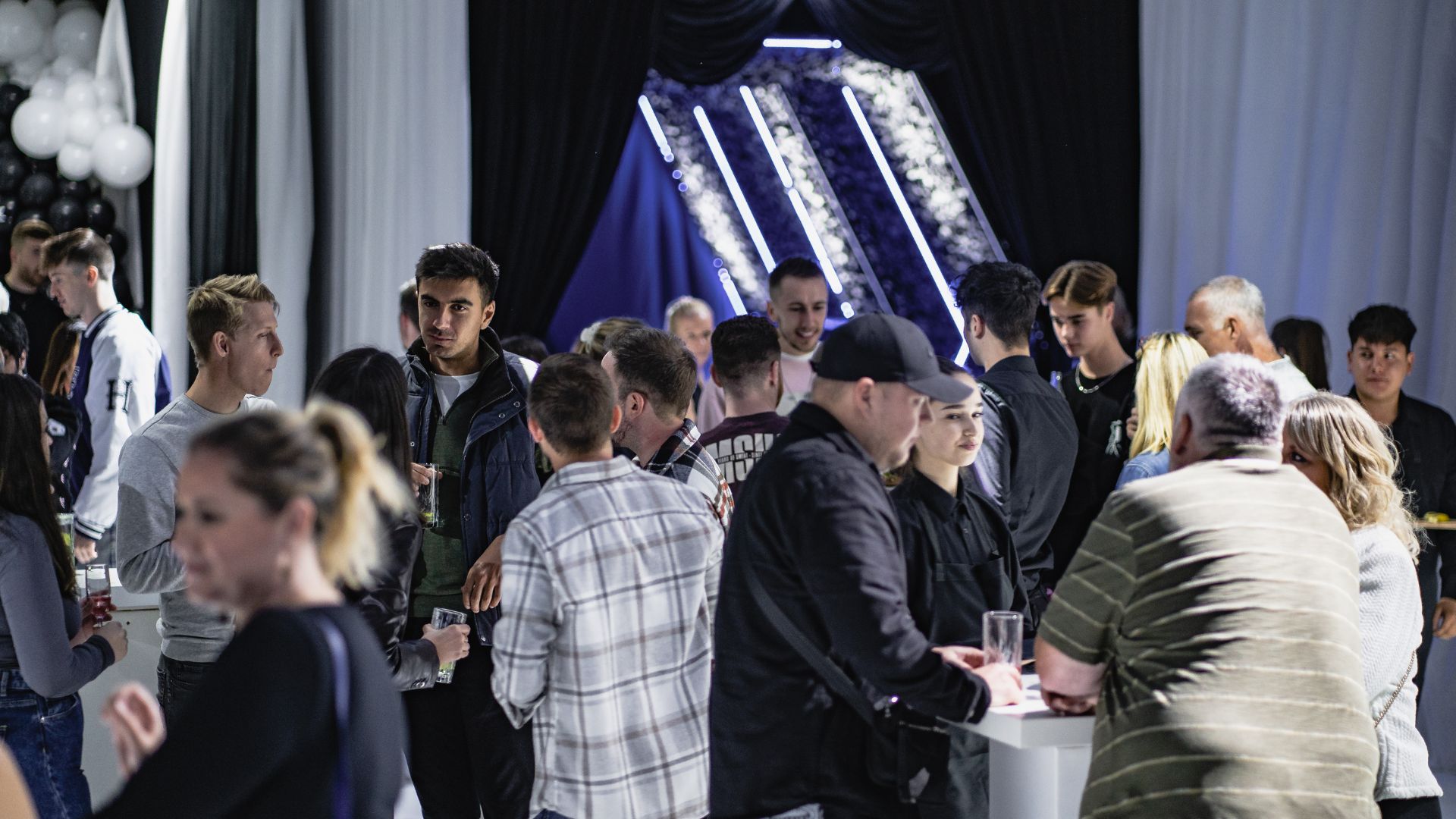 Guests socialising near the bar at the Sidemen charity match after party.