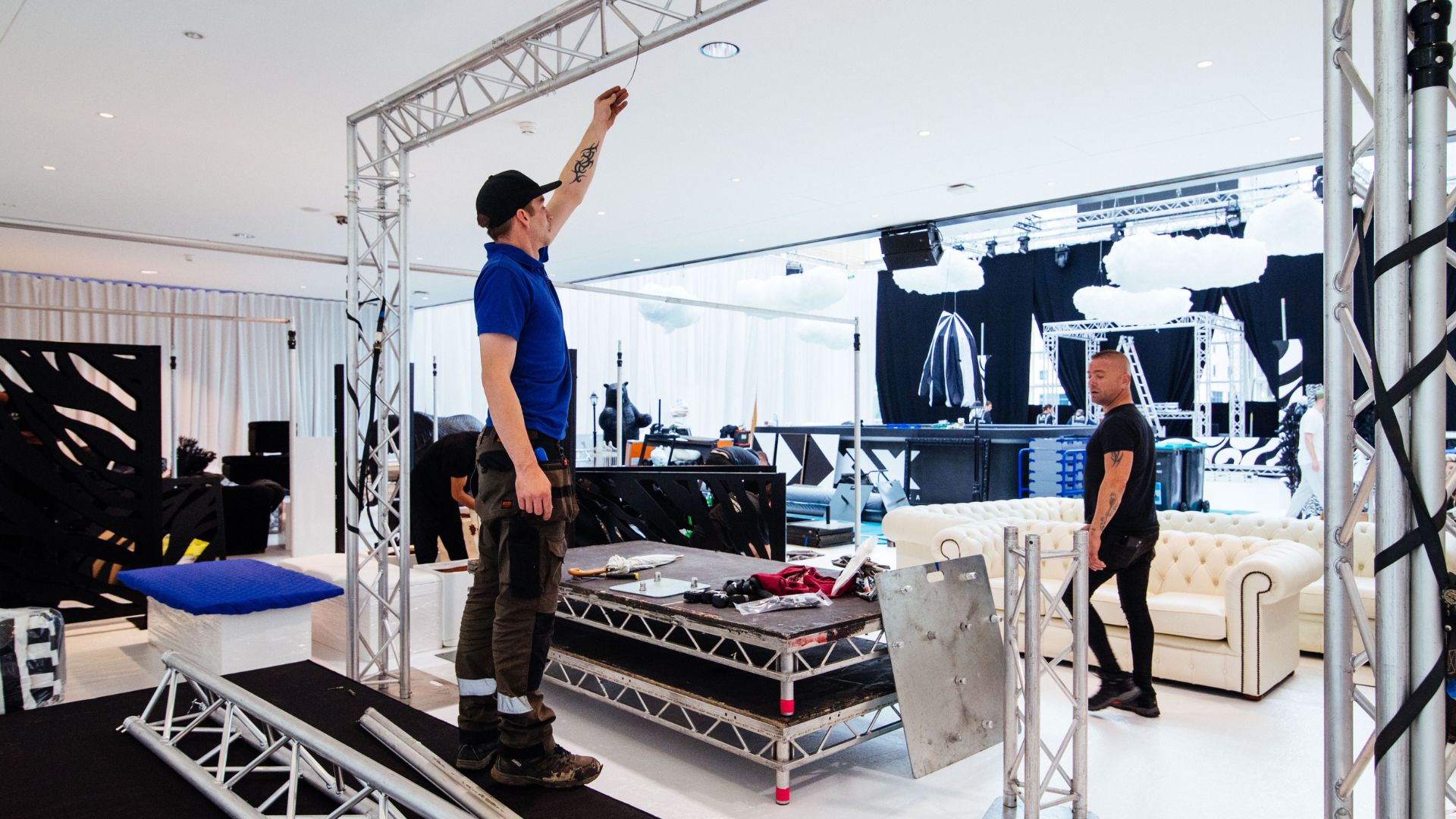 Julia Charles Event Management team setting up photo backdrop.