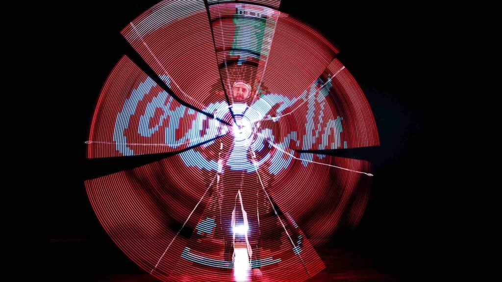 LED juggler creating coca cola logo with LED props