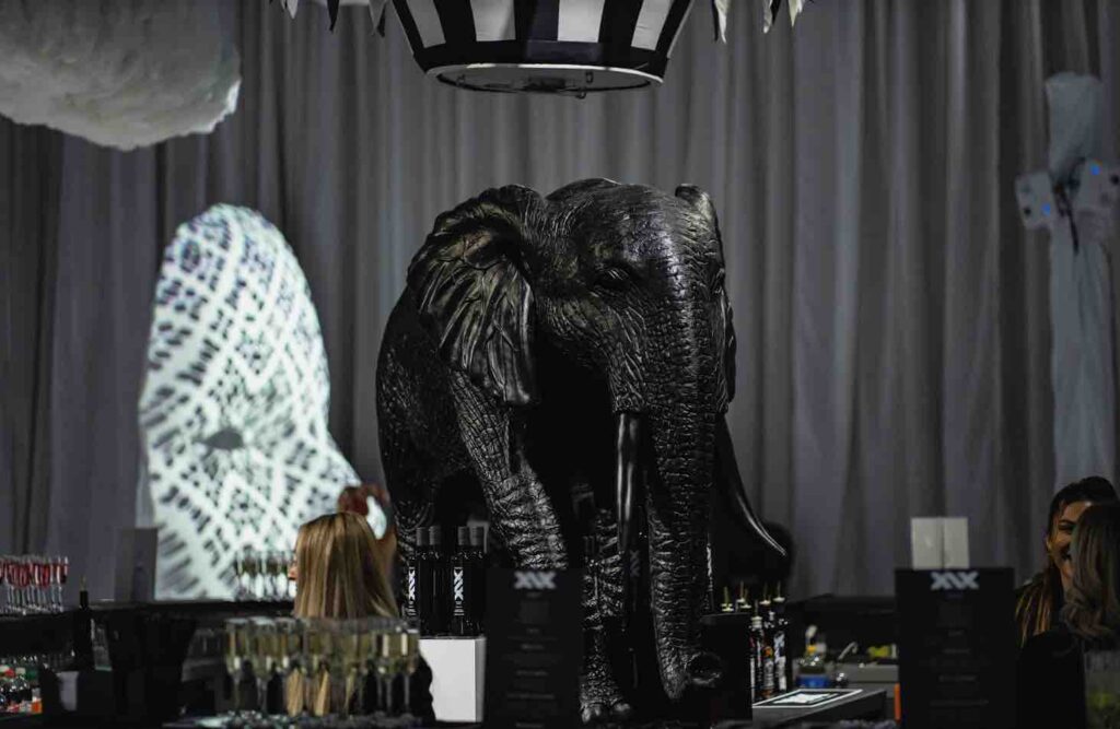 Large black elephant prop with black and white hot air balloon tied around his tummy. Prop in the centre of the room at dream circus party.