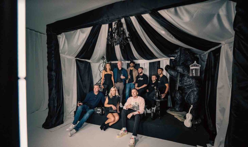 Guests from Sidemen dream circus party posing in black and white circus photo booth.