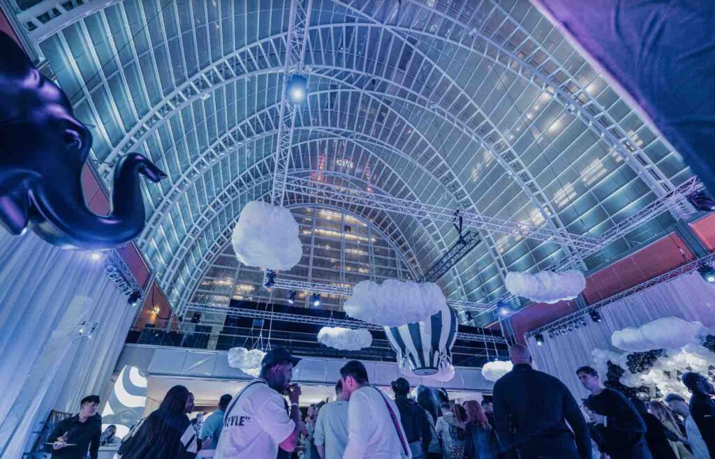 Ceiling covered in large cloud props of event space booked for dream circus party.