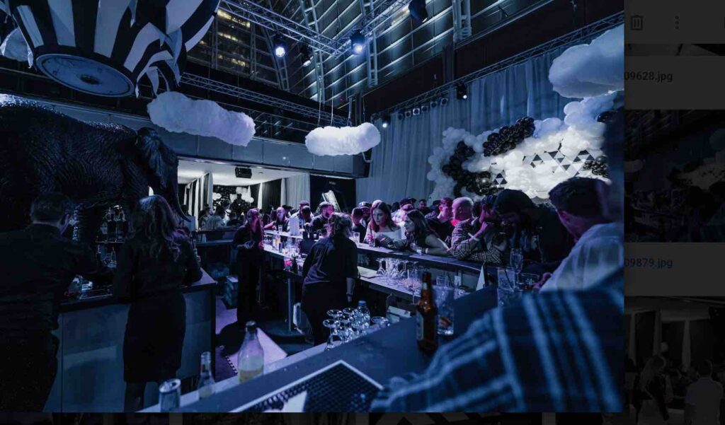 Bar staff serving drinks to guests at dream circus themed event.