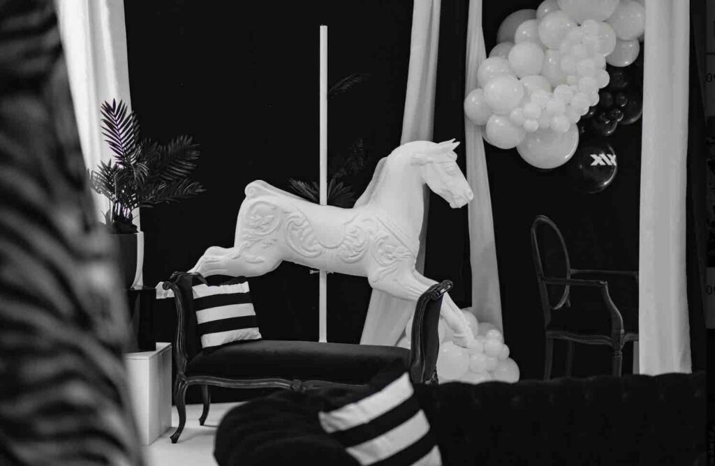 White carousel prop at dream circus themed event.