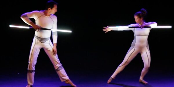Acrobatic-Performers-Holding-Light-Staffs