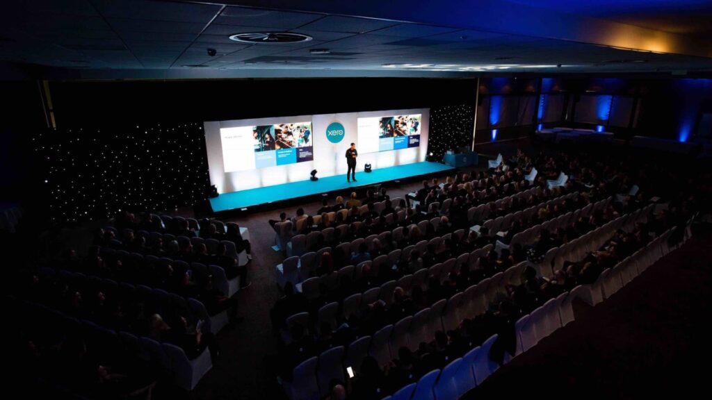 Aerial view of Xero conference event with guest speaker on bespoke stage produced by Julia Charles Event Management.