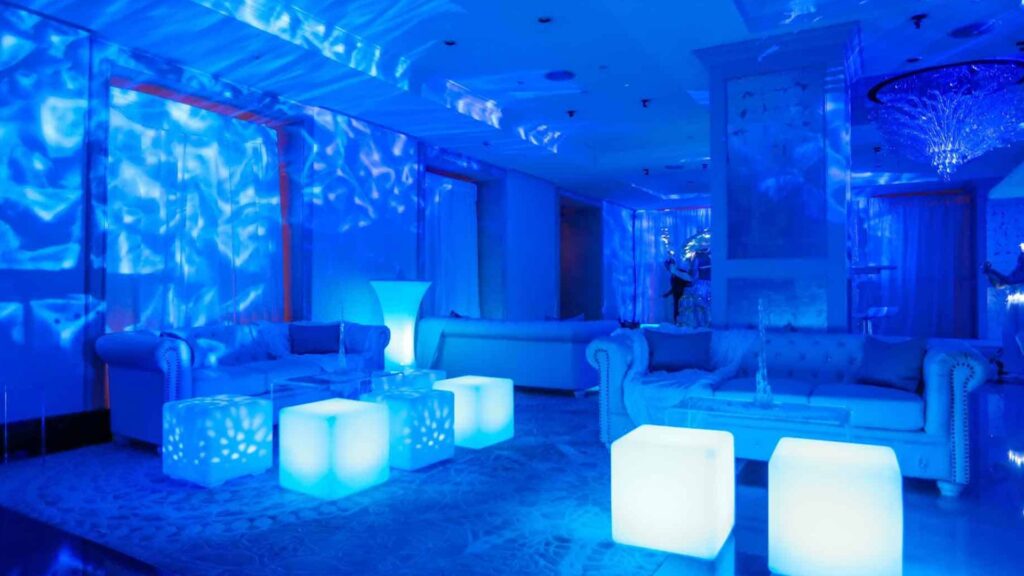 Winter Wonderland seating area with seating cubes, standing tables and lighting projections.