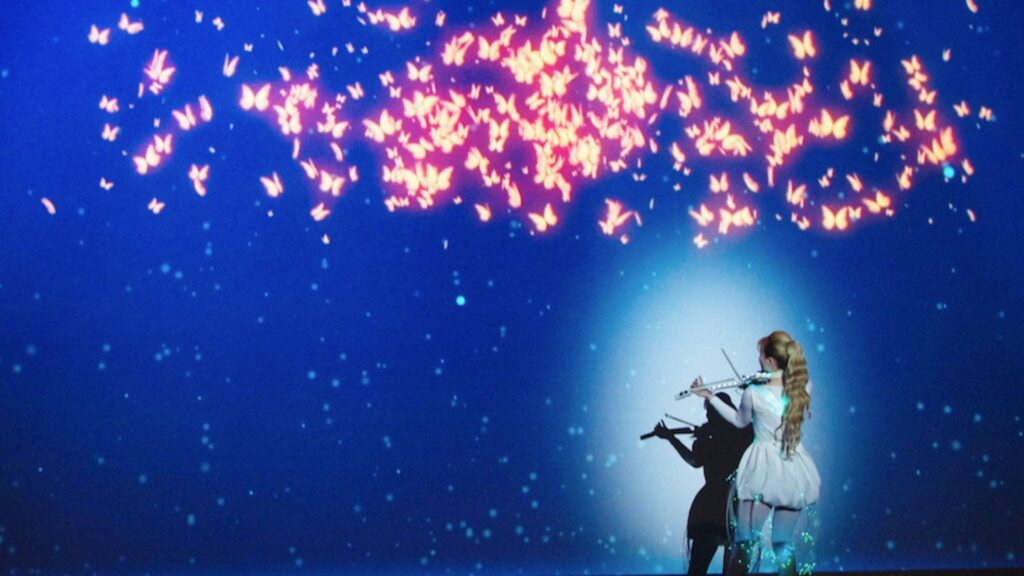 Violinist performing with butterfly projection mapping