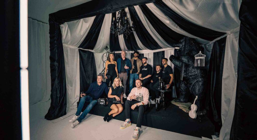 Guests post inside a black and white draped custom tipi at an event in London.