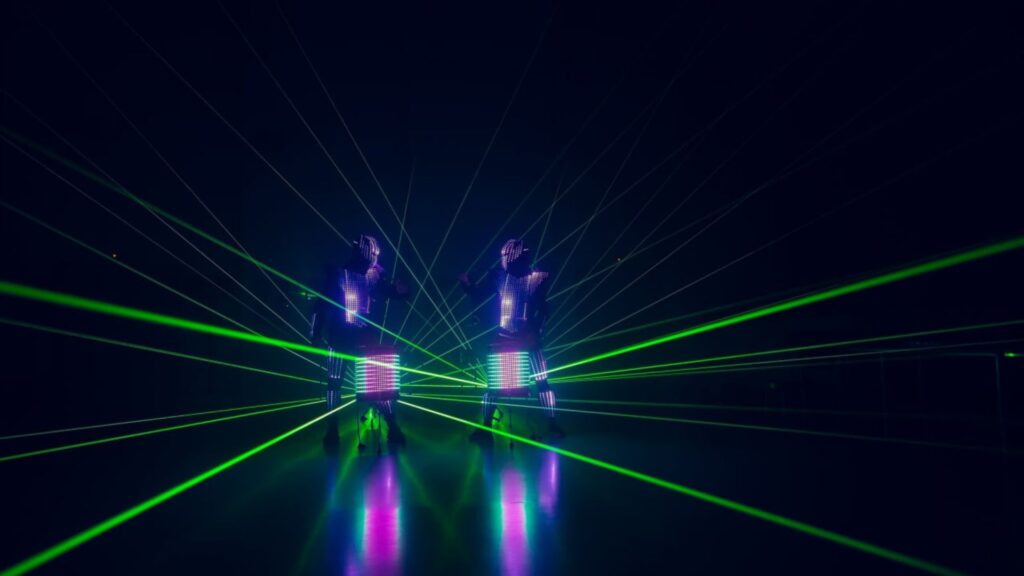 a visual drumming act stands on stage beating glowing LED drums