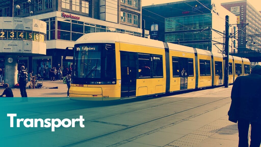 Public transport yellow tram on street.
