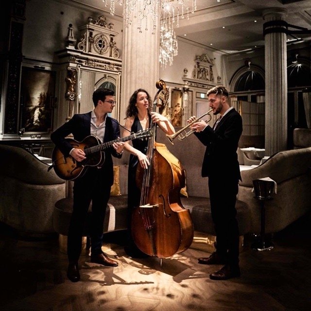 A traditional jazz band with a double bass at the centre plays at a stylish venue