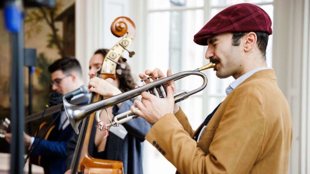 A jazz musician plays a trumpet with his jazz band