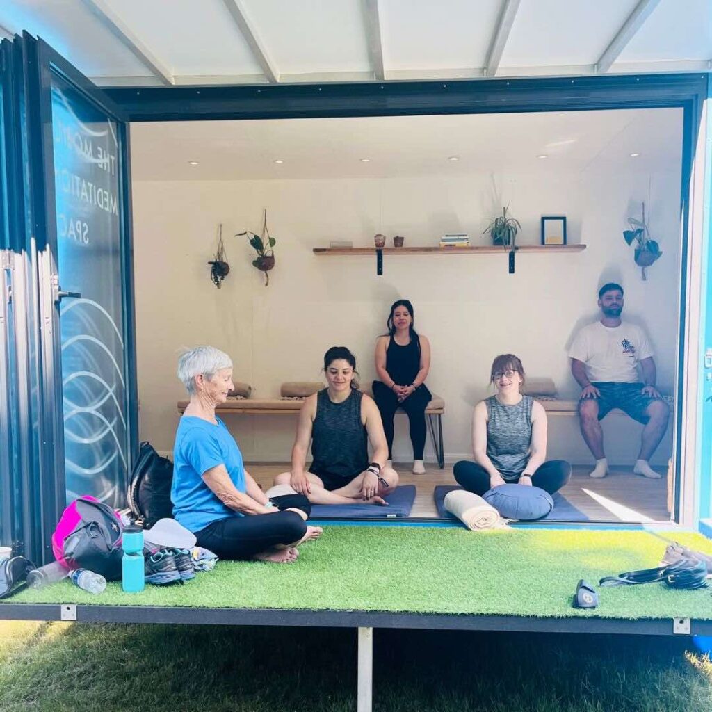A group of people inside a mobile meditation van