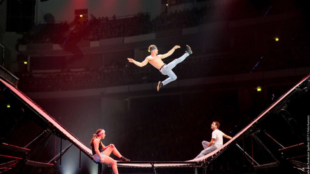 Acrobats perform during a trampoline show for guests