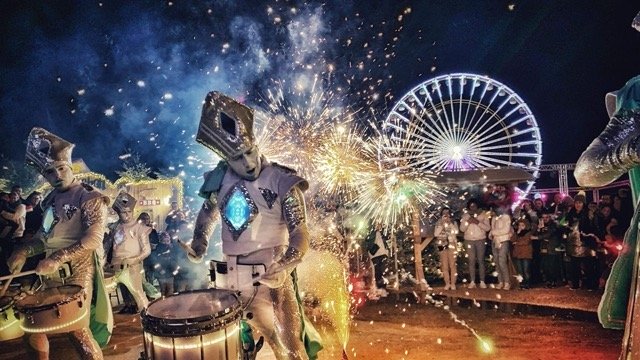 An LED drum group in white costume using light drums