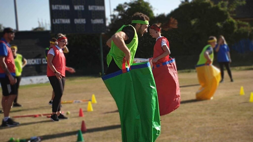 Family Fun Day Sports Themed Activity man jumping in a bag.