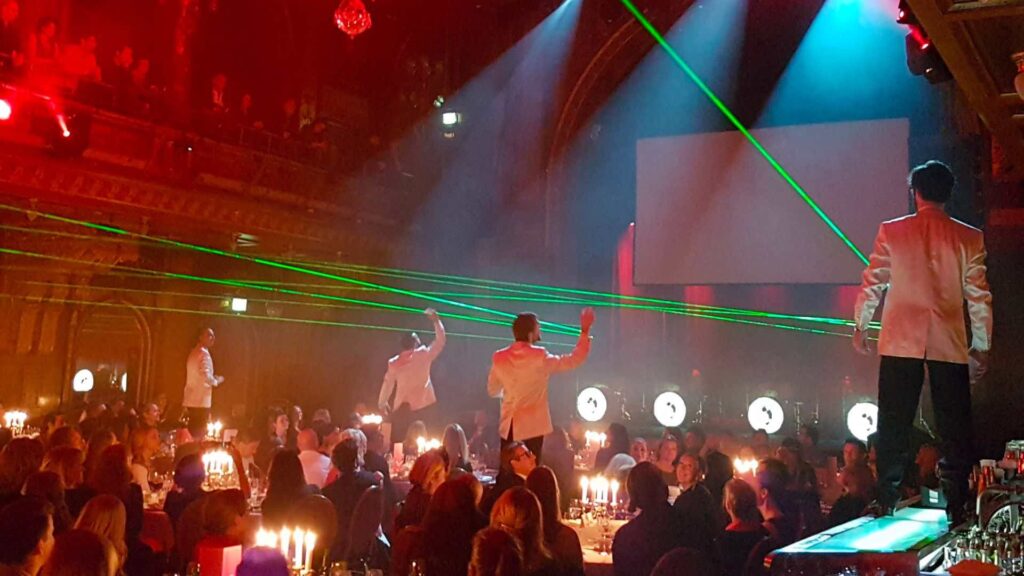 Lasers are played alongside music by a musician