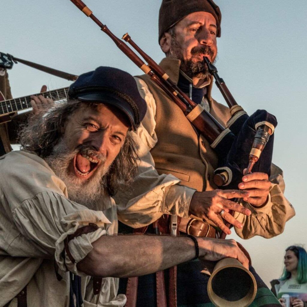 A merry sailor plays alongside his fellow band mate