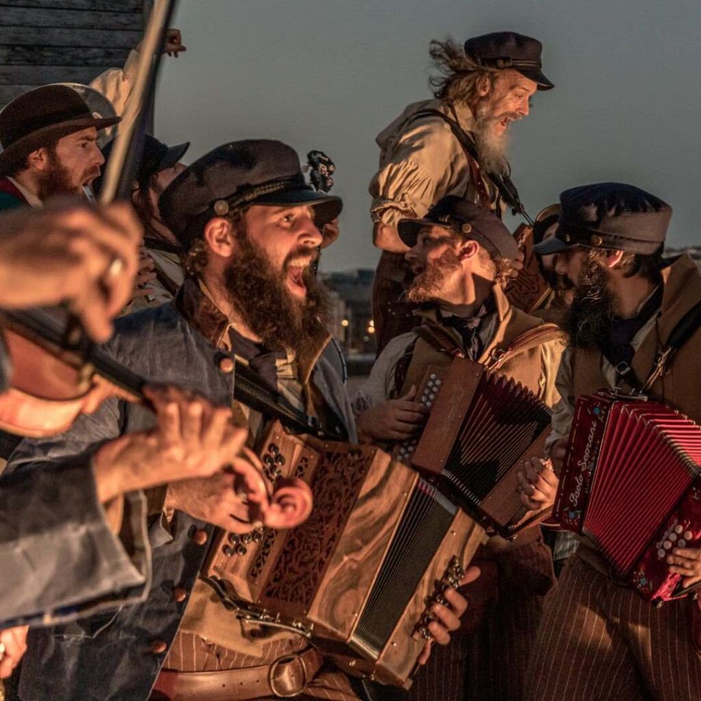 A band of shanty singers dressed as pirates regail in song