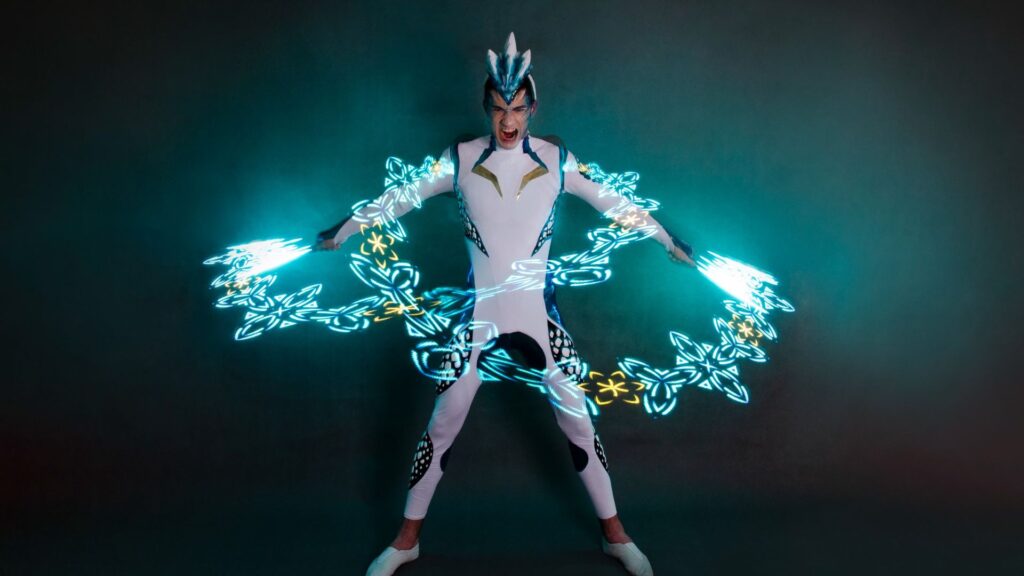 A light performers surrounded by a light projected pattern