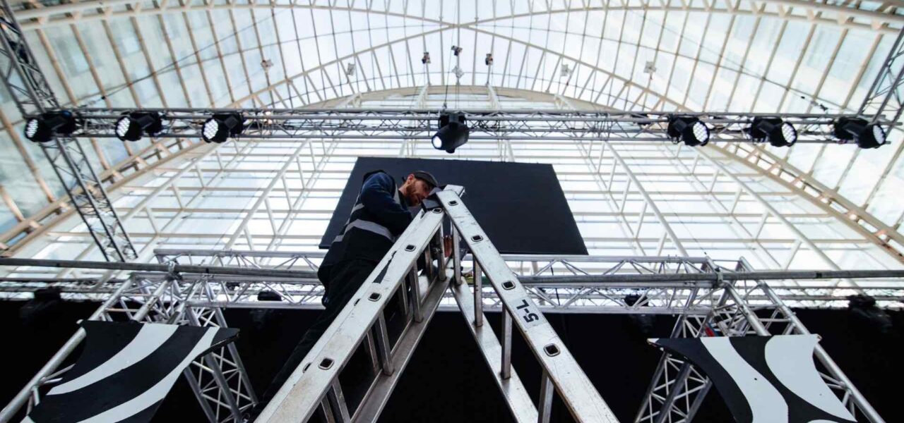 Technician-Setting-Up-Lighting-At-Event
