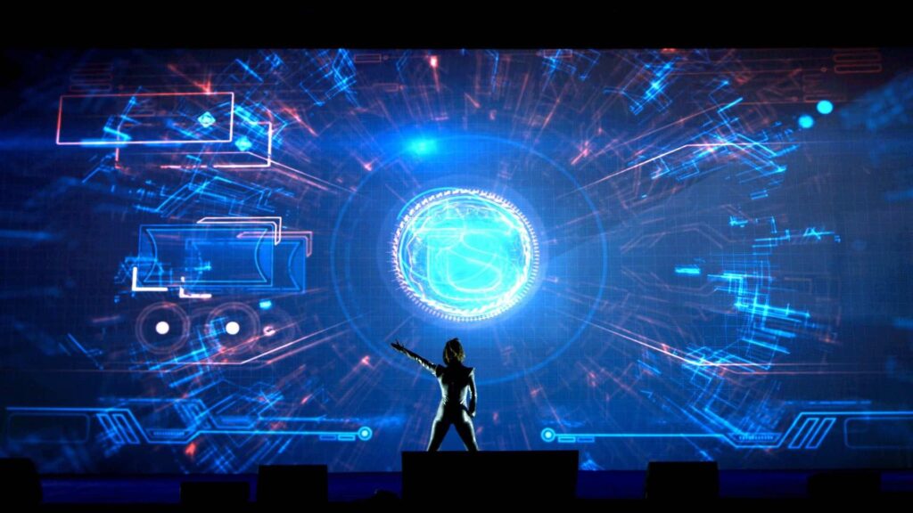A 3d projection of a blue sphere alongside a video mapping dancer